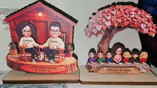 Reviewer's personalized heart tree wooden plaque shown on a surface next to another custom plaque.