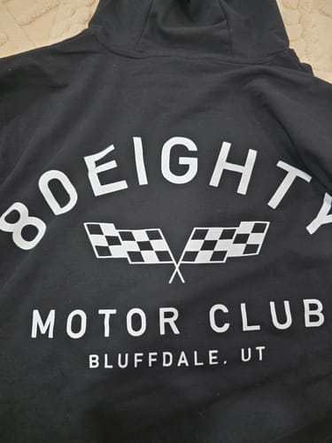 Reviewer's photo showing a close-up of the back of the black 80Eighty® MotorClub Hoodie with its white graphic.