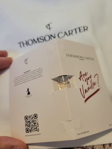 Customer holding a white sample card with a vial of Are You Vanilla Day Eau de Parfum.
