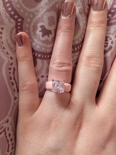 Reviewer's hand wearing the light pink Princess Cut CZ Silicone Ring with a large, sparkly stone.