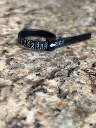 Customer's close-up of the black plastic Free Ring Sizer on a countertop.