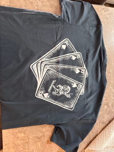 Reviewer's dark grey KING-HIGH shirt laid out, showing the poker card graphic on the back.