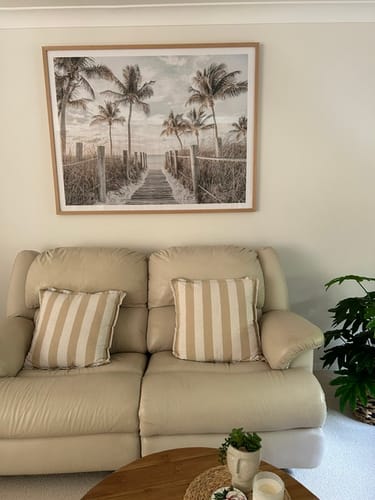 Reviewer's Florida Keys I | LS Art Print with an oak frame hung in a living room above a cream sofa.