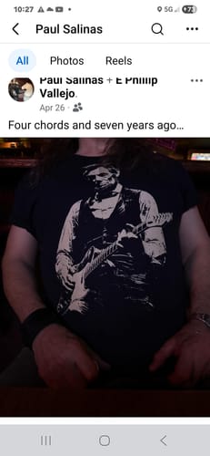 Customer wearing the black Lincoln Guitar T-Shirt, showing off the unique graphic.