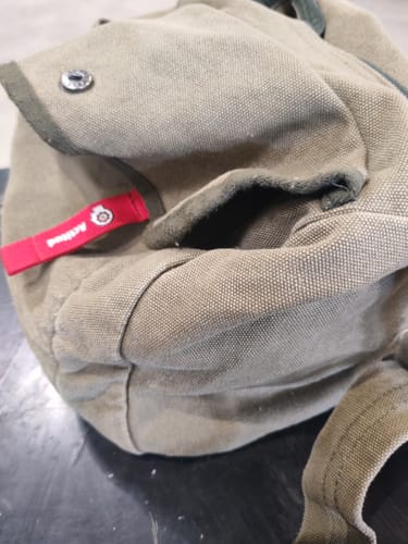 Close-up of the customer's Japan Style Canvas Bag, showing the textured material and a silver button.