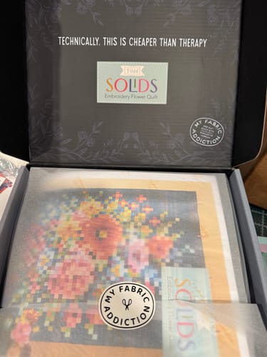 Customer's open box for the Tilda Embroidery Flower Precut Quilt Kit, showing the neatly packaged contents inside.