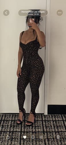 Reviewer posing in the full-length leopard print Burnout Print Jumpsuit.