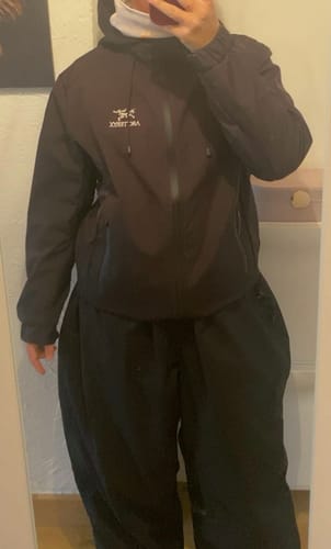 Reviewer taking a mirror selfie to show the oversized fit of the black Snow Pants.