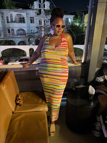Customer wearing the Spot Me If You Can Mixed Print Sunglasses outdoors on a patio at night.