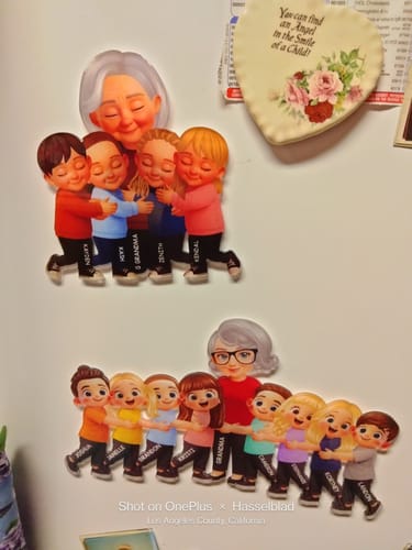 Reviewer's two personalized acrylic fridge magnets showing custom grandma and grandkids characters on a refrigerator.