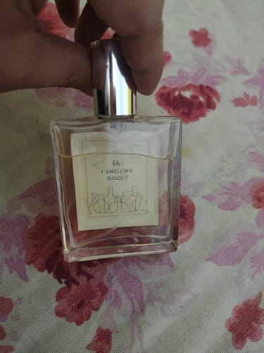 Customer holding the square glass bottle of Viking | Eau De Parfum with its silver cap.