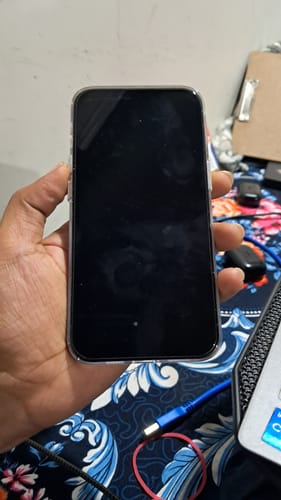 Customer holding a smartphone with the UltraShield Tempered Glass applied to the screen.
