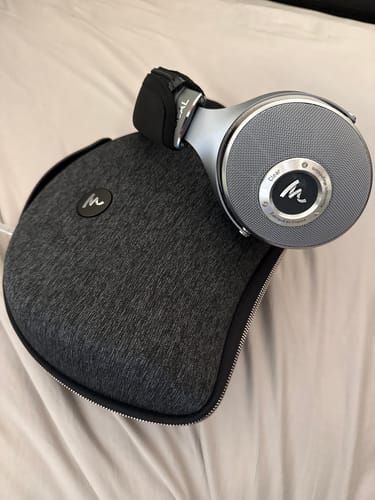 Customer's silver Focal Clear Headphones shown resting on top of their dark grey carrying case.