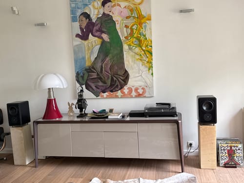 Reviewer's SA1 MK2 amplifier on a credenza with a turntable and speakers in a modern living room.