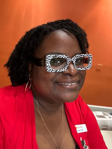 Reviewer smiling while wearing the funky Spot Me If You Can Mixed Print Sunnies.