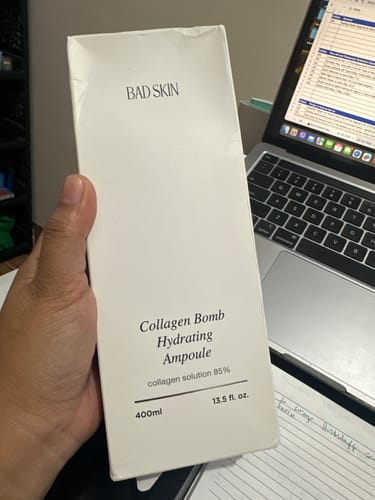 Customer holding the large 400ml box of Bad Skin Collagen Bomb Hydrating Ampoule.