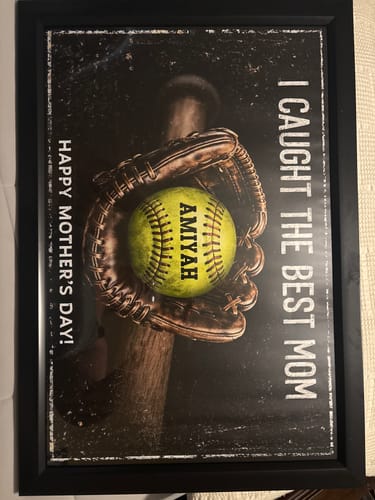 Customer's framed 'We Caught The Best Mom' poster, personalized with the name 'AMIYAH' on a softball held in a glove.