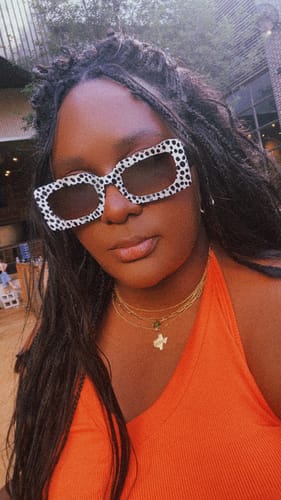 Reviewer in a close-up shot wearing the bold, dalmatian print sunglasses.