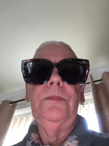 Customer's close-up selfie wearing the floral frame fit-over sunglasses.