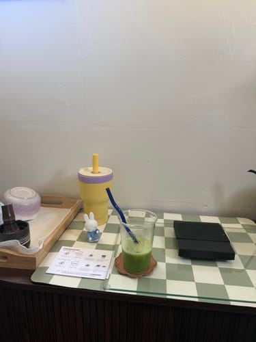 Customer's Miffy Hug-n-Hold Little Helper Figure in a blue outfit sitting on a checkered desk.