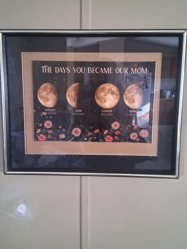 Customer's personalized Mom Birth Moon Phase poster, framed and hanging on a wall, displaying four moon phases.