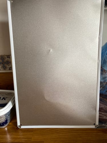 Customer's photo showing the dented metal back of the Funny Wall Art.