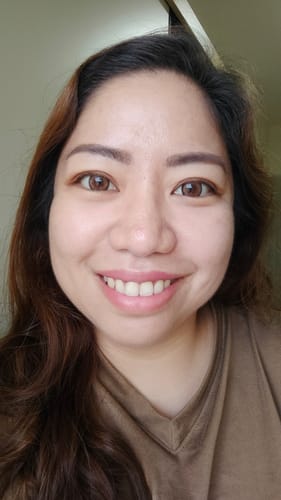 Reviewer smiling, showcasing the warm, natural Innocent Sepia Brown contact lenses in her eyes.