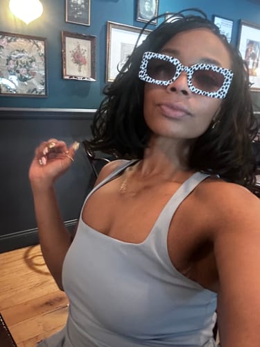 Reviewer posing indoors wearing the stylish Spot Me If You Can Mixed Print Sunglasses.