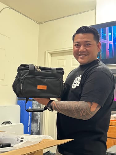 Customer holding the black Durable Enrforce Lunchbag from the Lunch Break Bundle.