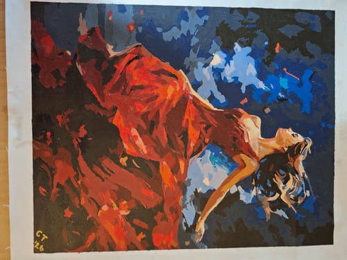 Reviewer's finished 'Dancer in Red' paint-by-numbers, showing a woman in a red dress against a dark blue background.