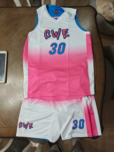 Customer's custom basketball uniform with a white and pink gradient jersey and matching shorts, featuring 'CWE' and the number 30.