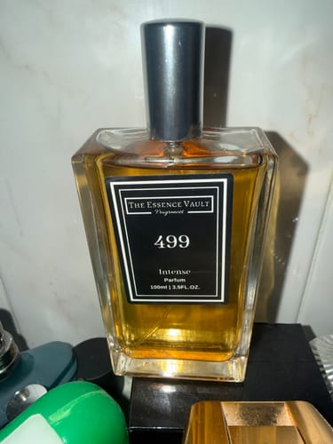 Customer's bottle of 499 - Intense perfume, showing the amber-colored liquid and black label.