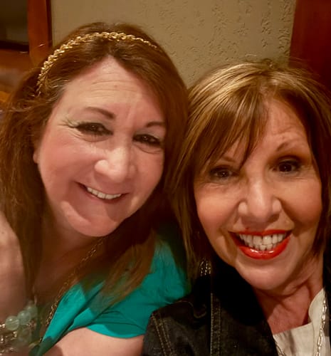 Reviewer and a friend smiling, showing off the reviewer's long lashes after using My Amazing Lashes Mascara.