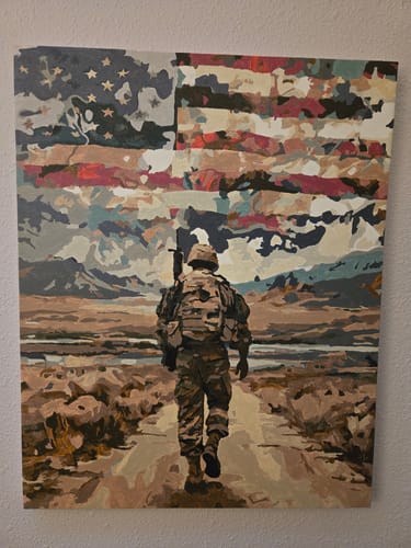 Customer's completed 'Homecoming Soldier' painting showing a soldier walking in a desert with a stylized American flag in the sky.