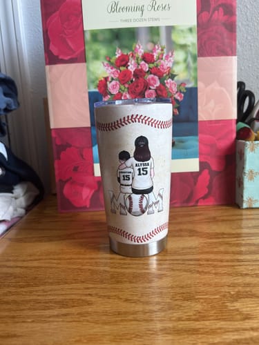 Customer's personalized tumbler with a baseball theme, featuring a graphic of a mom and son and the word 'MOM'.