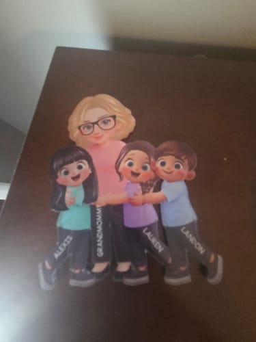 Customer's personalized acrylic fridge magnet showing a grandma character hugging three grandkids with their names printed on it.