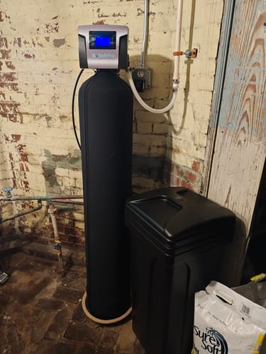 Customer's black SoftPro® Elite HE Water Softener system installed in a basement.