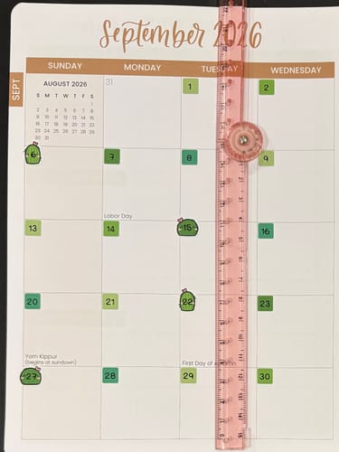 Customer's planner showing small, green Cozy Plants Date Dots stickers used on a monthly calendar view.