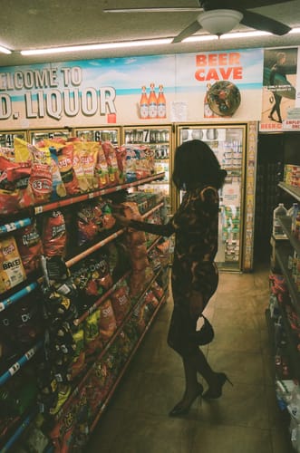 Customer wearing the printed Naked Print Capri Legging with a matching top in a store aisle.