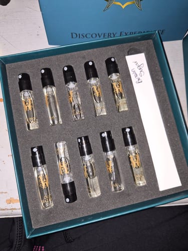 Customer's Discovery Set open, showing ten small perfume vials neatly arranged in the box.