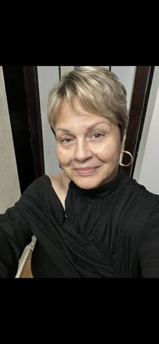 Reviewer's close-up view wearing the black loose T-shirt with an asymmetric collar.