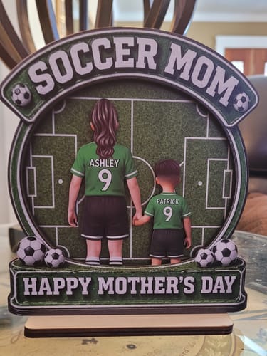Customer's personalized wooden 'Soccer Mom' plaque with two figures in green jerseys and 'Happy Mother's Day' text.
