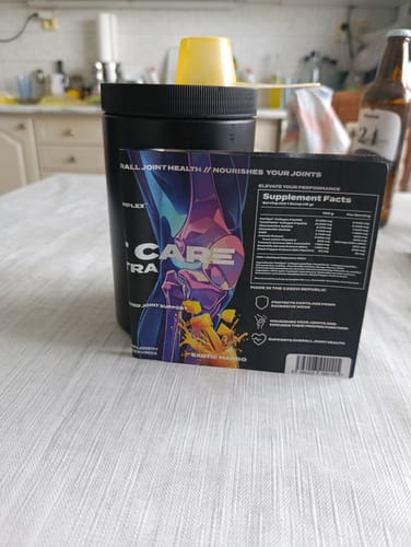 Customer's black tub of Joint Care Ultra with its informational packaging sleeve on a table.