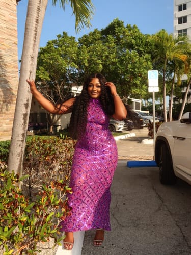 Reviewer posing outdoors in the sparkly purple Diamond Maxi Dress.