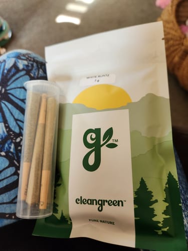 Customer's Blue Dream Pre Rolls in a clear tube next to the cleangreen brand pouch.