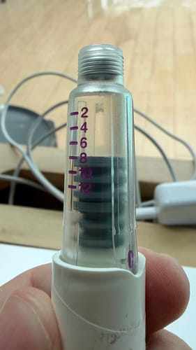 Customer's close-up of the Genotropin GoQuick Pen, showing the clear cartridge and its measurement marks.