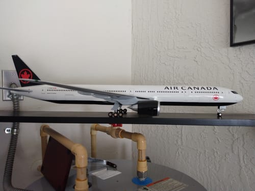 Customer's SKYMARKS AIR CANADA 777-300 model displayed on a black shelf in a garage.