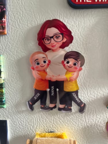 Customer's personalized acrylic magnet showing a grandma and two grandkids, Jesse and Johnny, on a refrigerator.