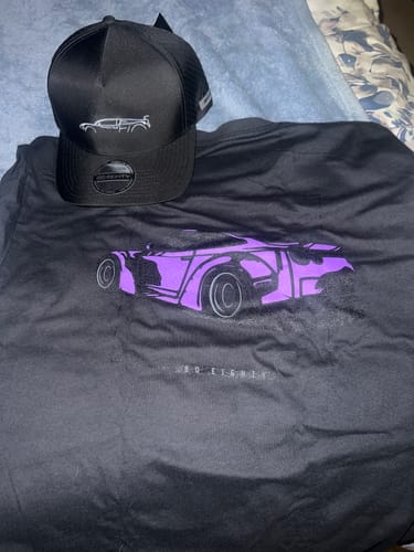 Customer's black DCG89 Hat with a white car outline, displayed on top of a black graphic t-shirt.