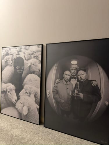 Customer's two framed 'Built Different' black and white art prints displayed side-by-side in a room.